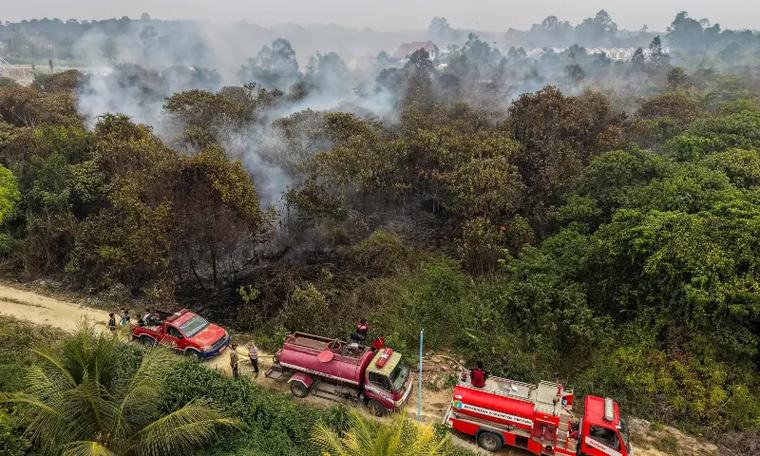 Indonesia conducts water bombing near future capital to curb wildfires