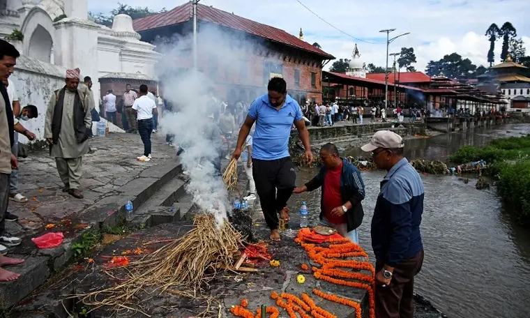 'We had to do this to set his soul free': Families hold symbolic funerals in Nepal for missing flood victims